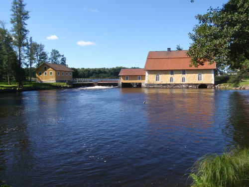 The castle is at a river with a mill.